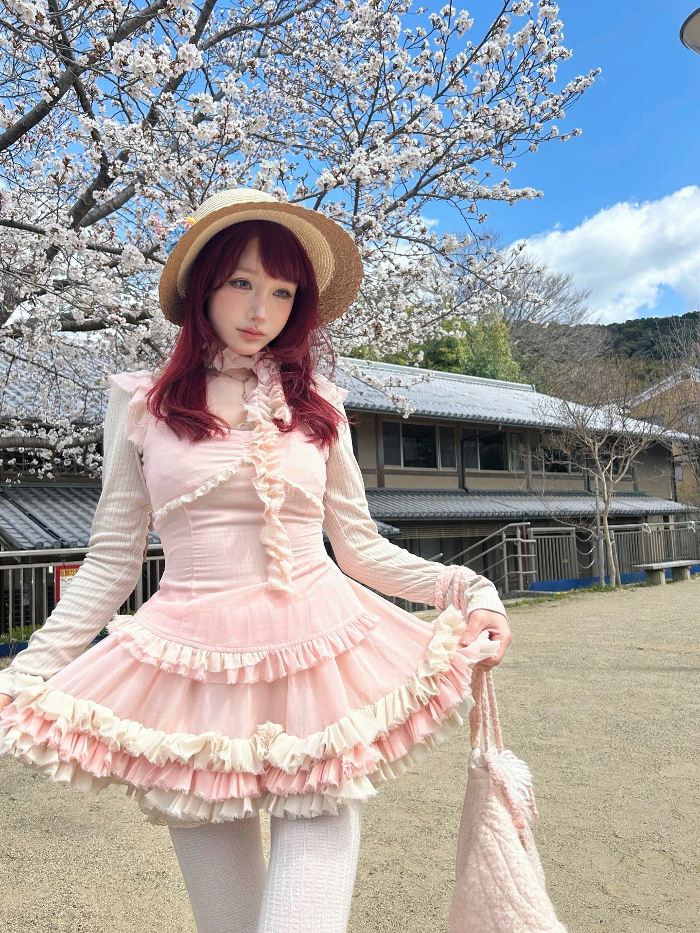 model wearing pastel pink coquette-style mini dress outdoors