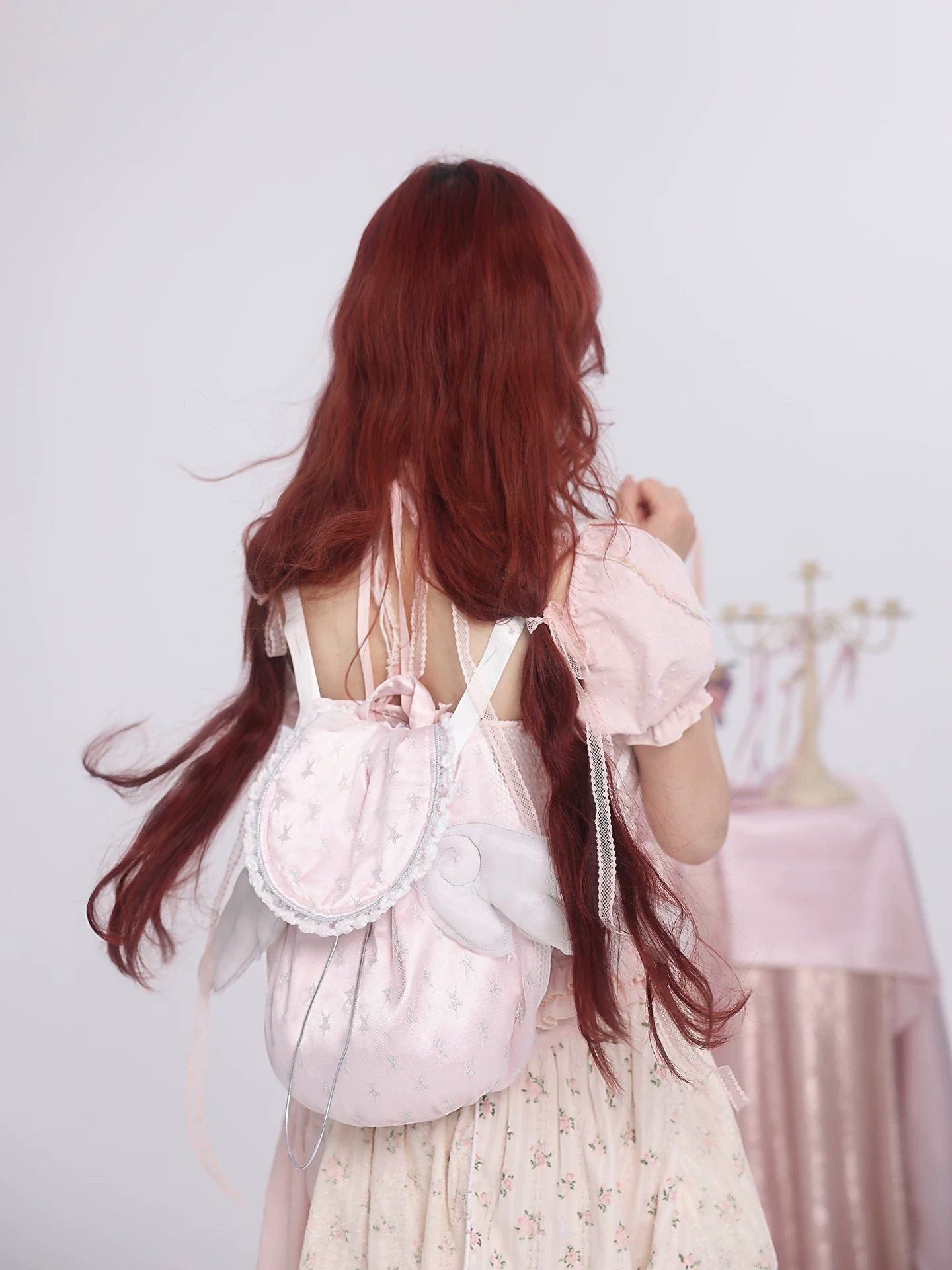 Rose island flying wings backpack wearing on model, back view with studio photo