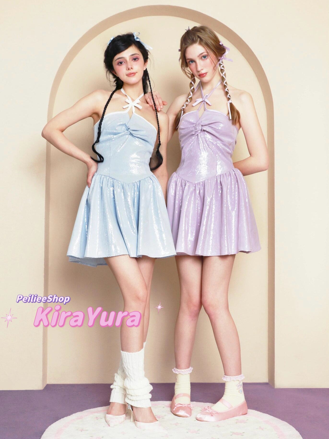 Two young women wearing glittery pastel-colored minin dresses standing in front of a beige archway.