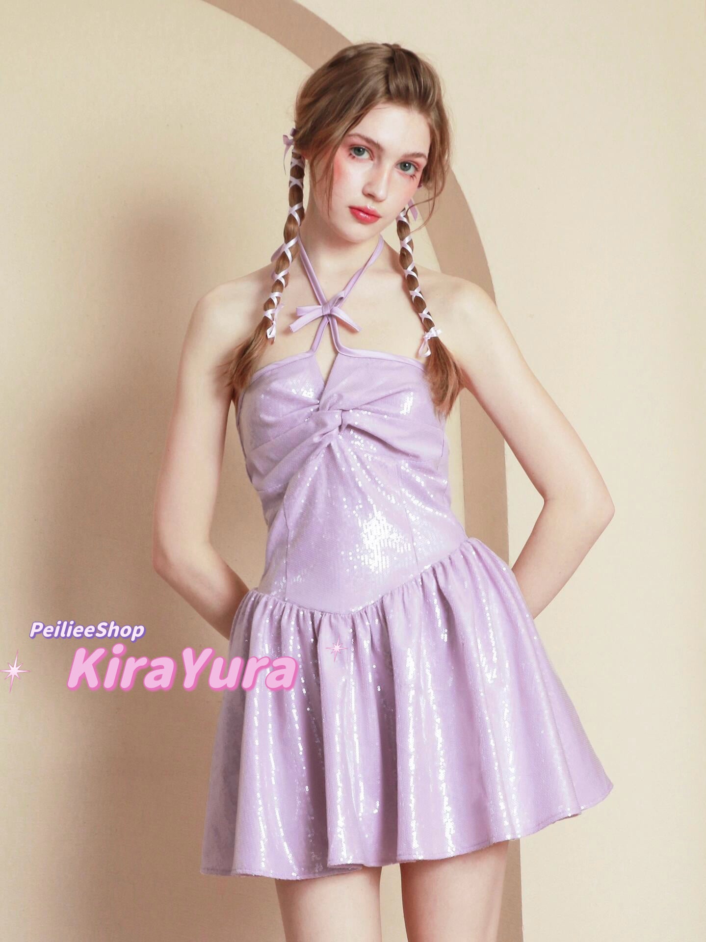 young woman wearing a purple glittery mini dress with a plain background
