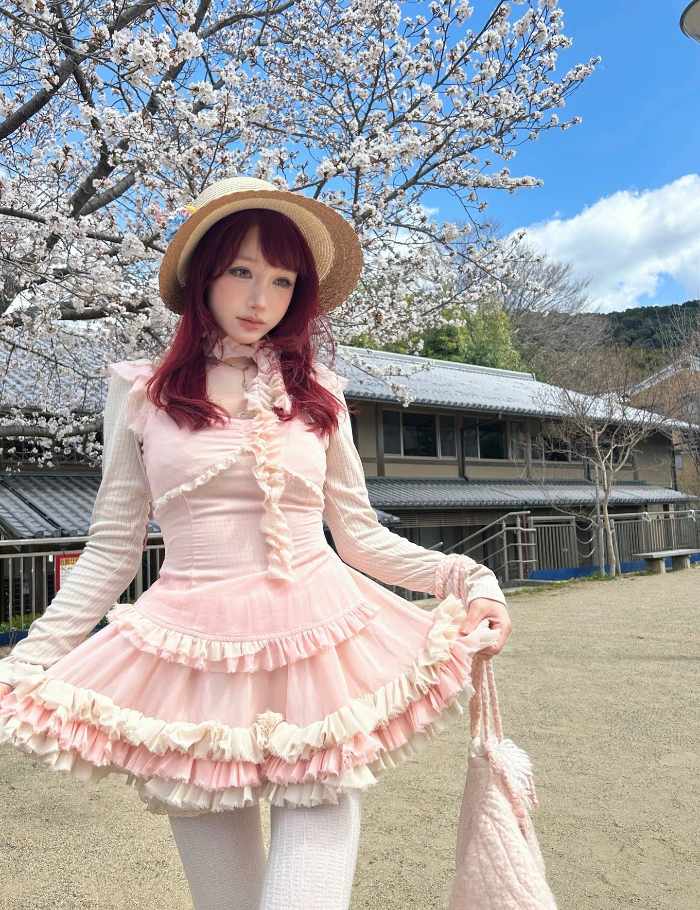 model wearing pastel pink coquette-style mini dress outdoors
