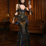 Person in a detailed, ornate dress holding a glass in a dimly lit room.