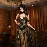 Woman in a gold and black dress standing in an opulent room with chandelier and curtains.