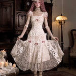 Woman in a detailed vintage white dress with lace and floral patterns in Japanese Gothic Lolita Fashion style.