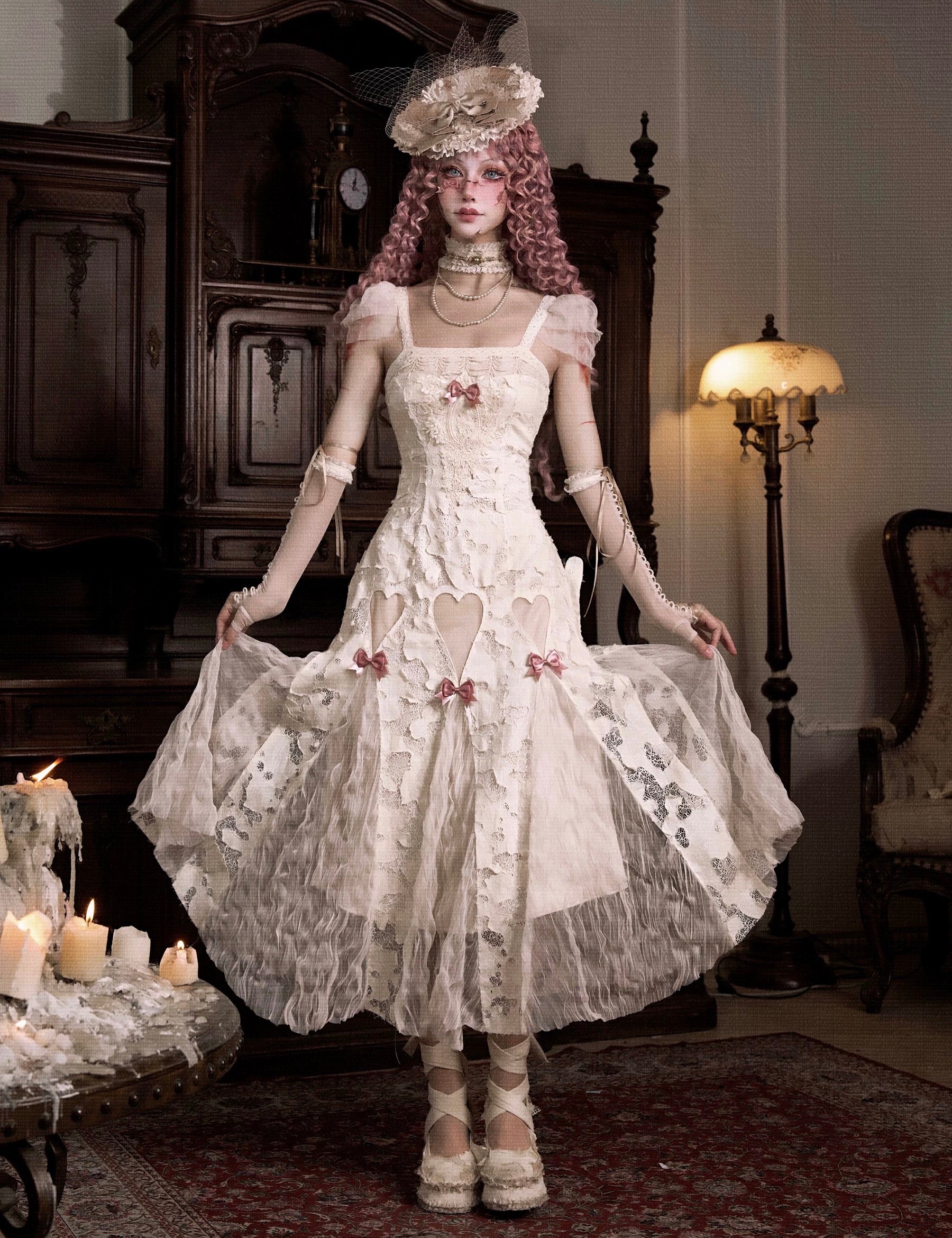 Woman in a detailed vintage white dress with lace and floral patterns in Japanese Gothic Lolita Fashion style.
