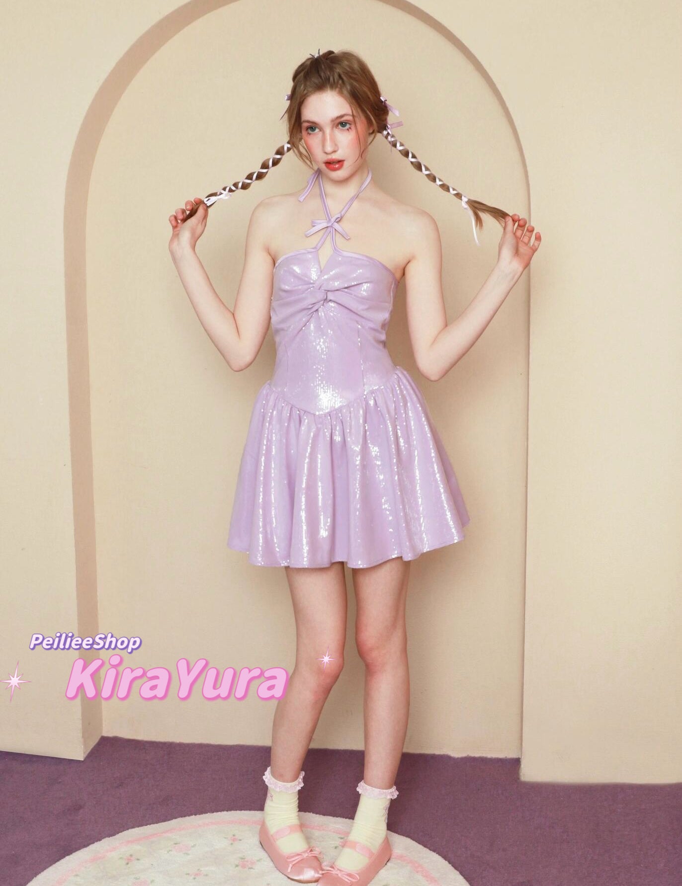 Woman in a purple glitter minin dress standing in front of an archway with 'PeilieeShop KiraYura' branding.