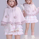 Two girls wearing matching pink and white outfits with cat ears faux fur fluffy cape front view