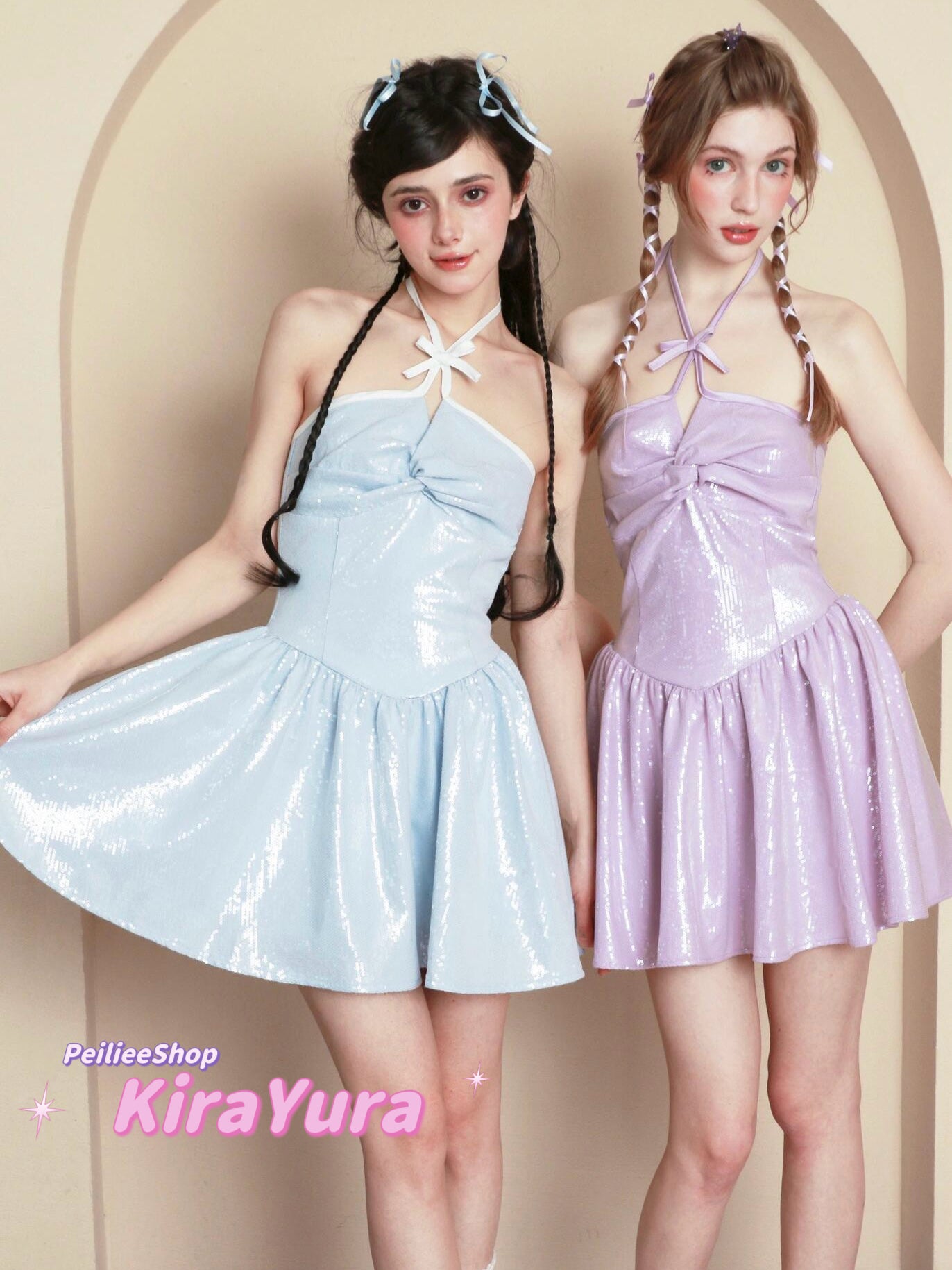 Two women wearing light blue and pink harajuku glitter dresses with a beige background.