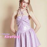 young woman wearing a purple glittery mini dress with a plain background