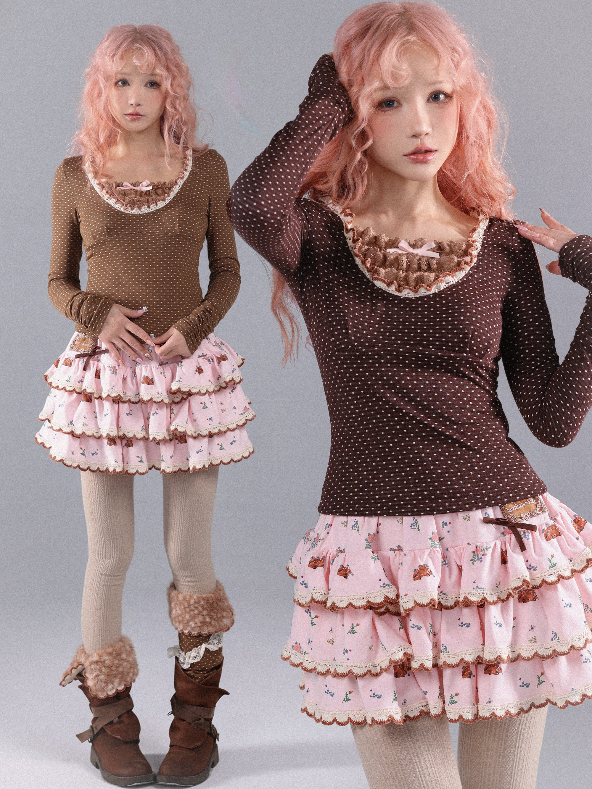 Two women wearing matching polka pot print sweatshirt with brown tops and pink ruffled skirts on a plain background.