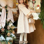 Girl in a plaid deer fawn print faux fur coat standing next to a decorated Christmas tree in a store in winter.